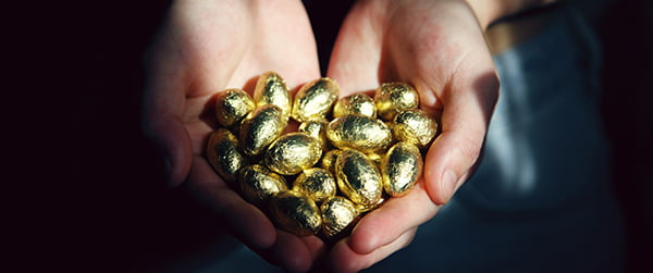 Hand full of gold eggs