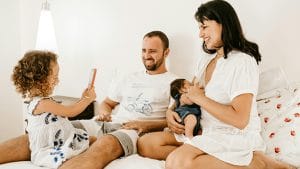 couple with two small kids, happy at home after changing lenders at mortgage renewal.